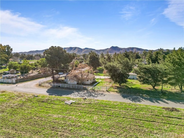 exterior space featuring fence and a mountain view