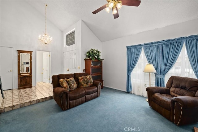 carpeted living area featuring high vaulted ceiling and ceiling fan with notable chandelier