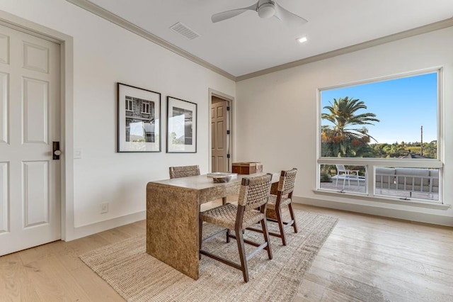 dining room featuring visible vents, ceiling fan, baseboards, ornamental molding, and light wood-style floors