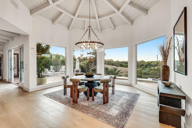 sunroom / solarium with visible vents, wood ceiling, a chandelier, and vaulted ceiling with beams