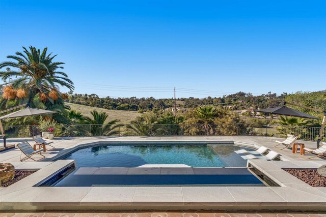 7102 Via De Maya, Rancho Santa Fe, CA 92067 - view of swimming pool featuring fence, a patio area, and a hot tub