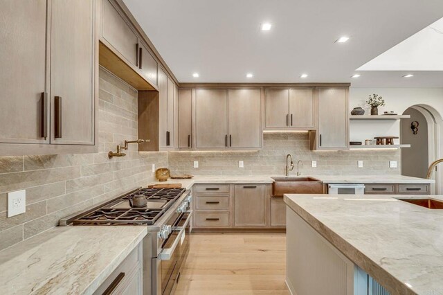 7102 Via De Maya, Rancho Santa Fe, CA 92067 - kitchen with range with two ovens, open shelves, decorative backsplash, light wood-style floors, and recessed lighting