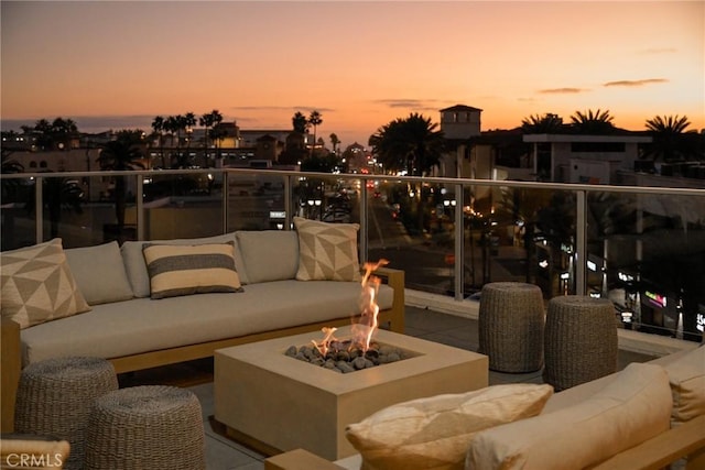414 Main Unit 230, Huntington Beach, CA 92648 - patio terrace at dusk featuring a balcony and an outdoor living space with a fire pit
