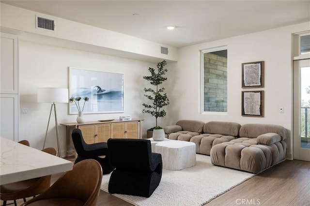 414 Main Unit 230, Huntington Beach, CA 92648 - living area with wood finished floors, plenty of natural light, and visible vents