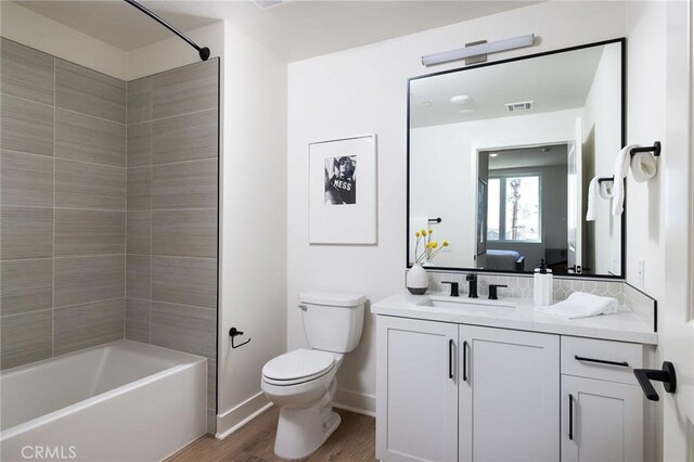 414 Main Unit 230, Huntington Beach, CA 92648 - bathroom with toilet, vanity, wood finished floors, baseboards, and visible vents