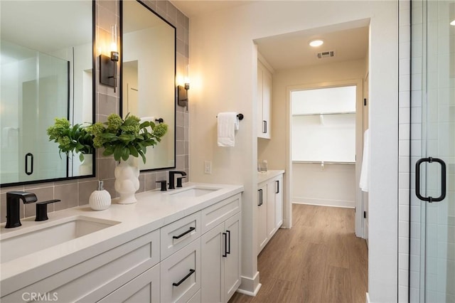 414 Main Unit 230, Huntington Beach, CA 92648 - full bath with a shower stall, visible vents, backsplash, and a sink