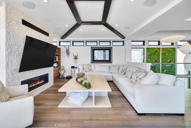 living room with a large fireplace, recessed lighting, beamed ceiling, and wood finished floors