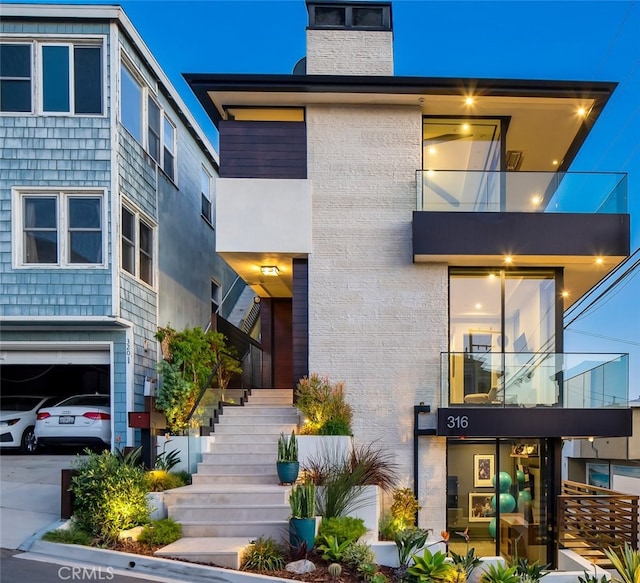 contemporary home with stairs and a chimney