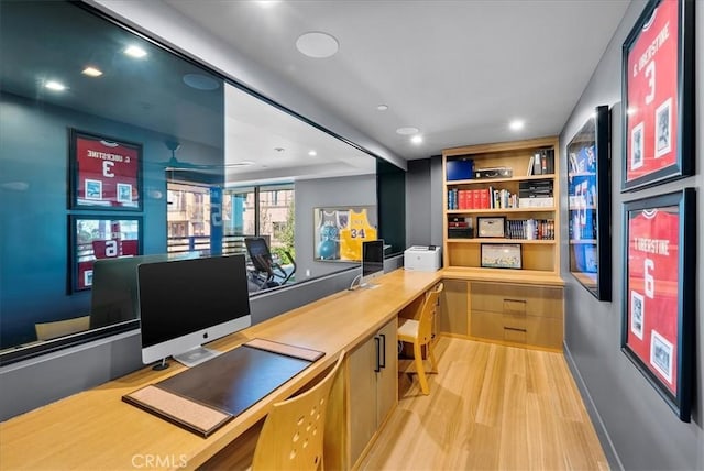 office space featuring light wood-style floors, recessed lighting, and built in study area