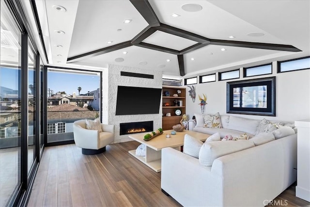 living room with recessed lighting, a large fireplace, plenty of natural light, and wood finished floors