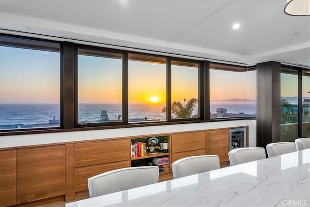 dining room featuring recessed lighting and a water view