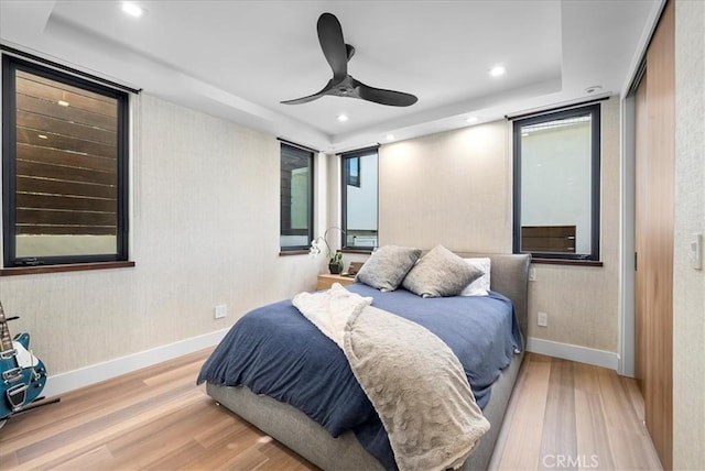 bedroom featuring a ceiling fan, recessed lighting, baseboards, and wood finished floors