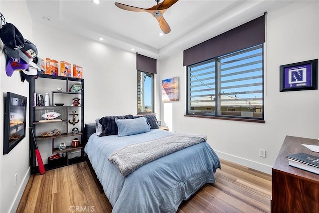 bedroom featuring recessed lighting, wood finished floors, a ceiling fan, and baseboards