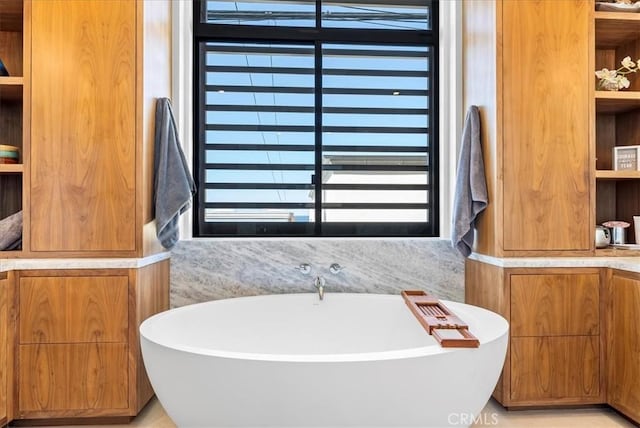 full bathroom featuring a soaking tub