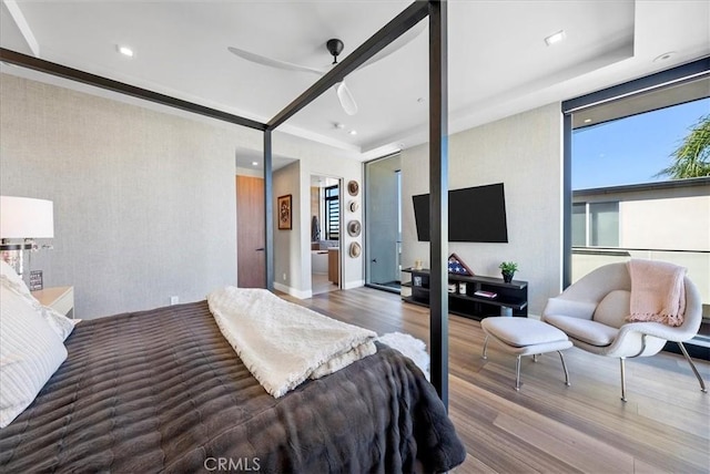 bedroom with multiple windows, a ceiling fan, wood finished floors, and recessed lighting