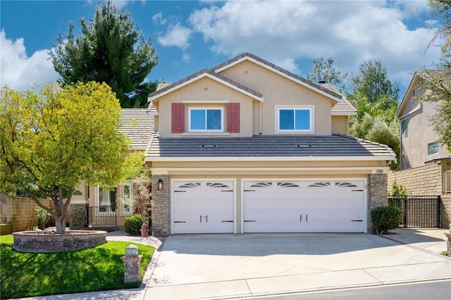 traditional-style house with driveway, a garage, fence, and a tiled roof