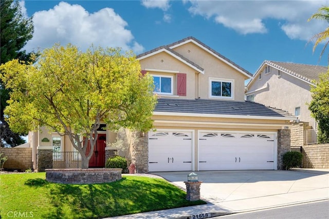 traditional home featuring a tiled roof, fence, concrete driveway, and stucco siding