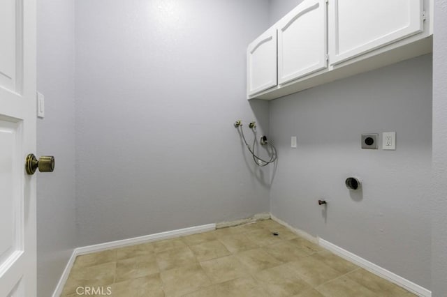 clothes washing area featuring washer hookup, cabinet space, electric dryer hookup, gas dryer hookup, and baseboards