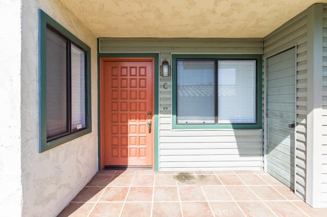 doorway to property featuring stucco siding