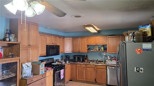 kitchen with open shelves, light tile patterned floors, stainless steel appliances, and a sink