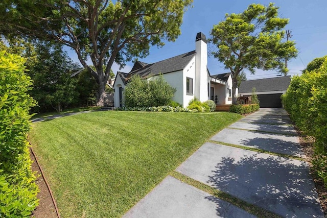 view of property exterior with a yard, a chimney, and stucco siding