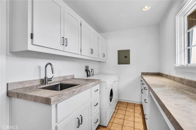 washroom with light tile patterned floors, cabinet space, a sink, electric panel, and independent washer and dryer