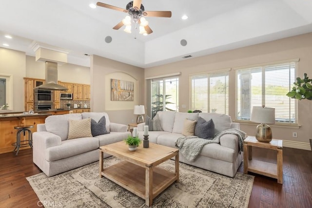 living area with visible vents, dark wood finished floors, and a wealth of natural light