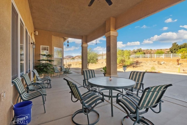 view of patio / terrace featuring outdoor dining area, fence, and a ceiling fan