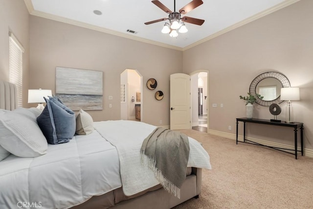 bedroom with arched walkways, carpet, crown molding, visible vents, and baseboards