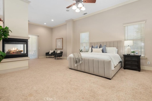 bedroom with carpet, visible vents, baseboards, ornamental molding, and a multi sided fireplace