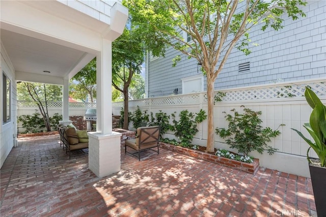 view of patio / terrace with grilling area and a fenced backyard