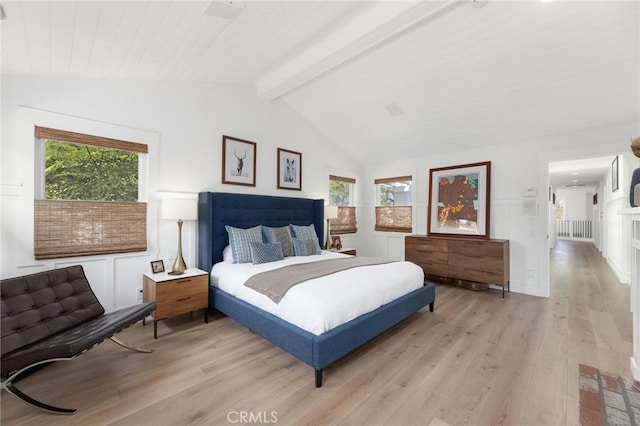 bedroom featuring lofted ceiling with beams and light wood-style floors