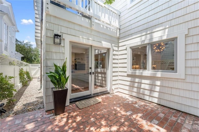 doorway to property featuring a patio area and fence