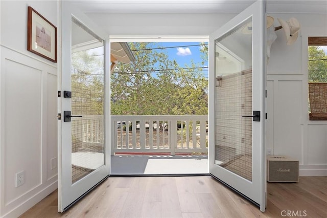 entryway with a decorative wall and wood finished floors