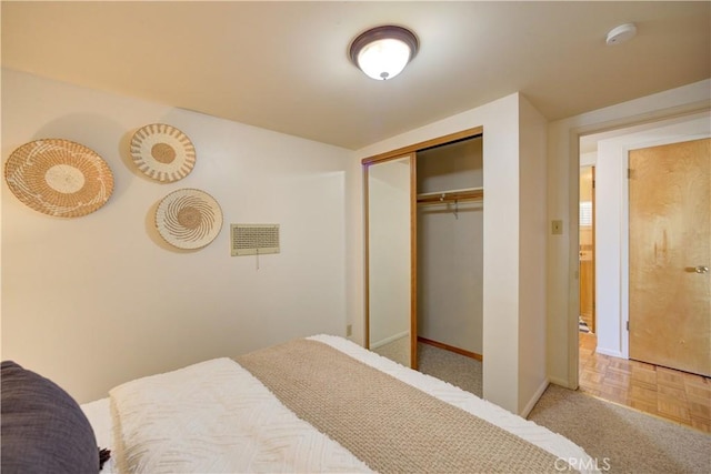 bedroom with a closet, visible vents, and baseboards