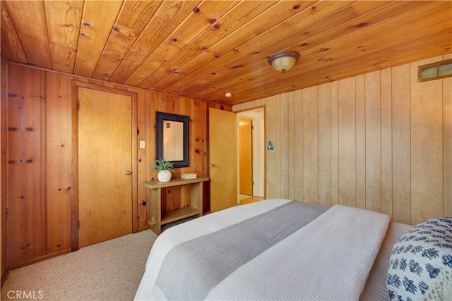 bedroom with carpet floors, wooden ceiling, and wooden walls