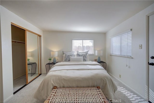 bedroom featuring carpet, baseboards, and a closet