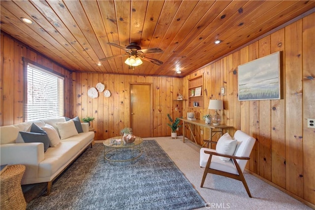 living room featuring wood walls, wooden ceiling, and light colored carpet