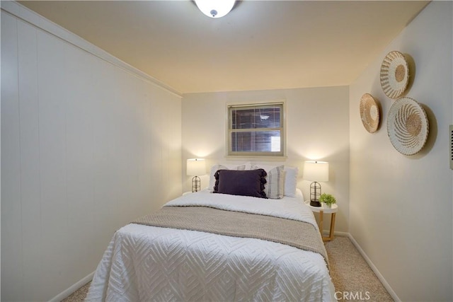 bedroom featuring light colored carpet and baseboards