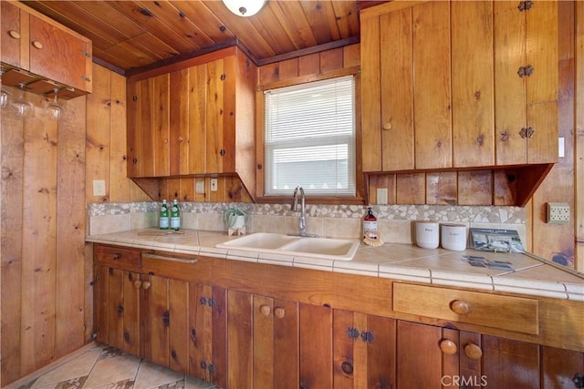 kitchen featuring brown cabinetry and a sink