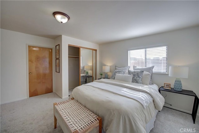 bedroom with light carpet and a closet