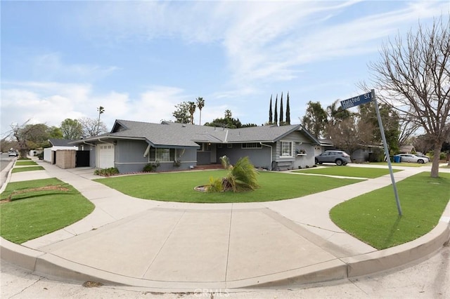 ranch-style house with an attached garage, a front lawn, and concrete driveway