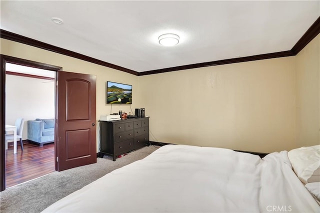 bedroom featuring light carpet, ornamental molding, and baseboards