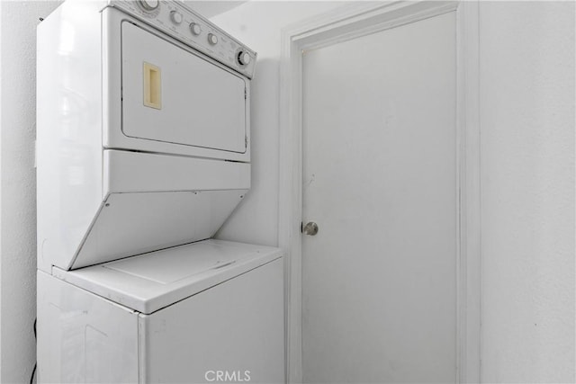 laundry room featuring laundry area and stacked washer / dryer