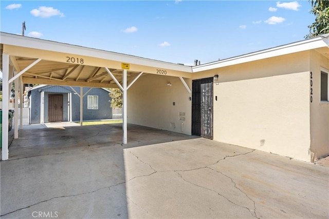 exterior space with a carport and concrete driveway