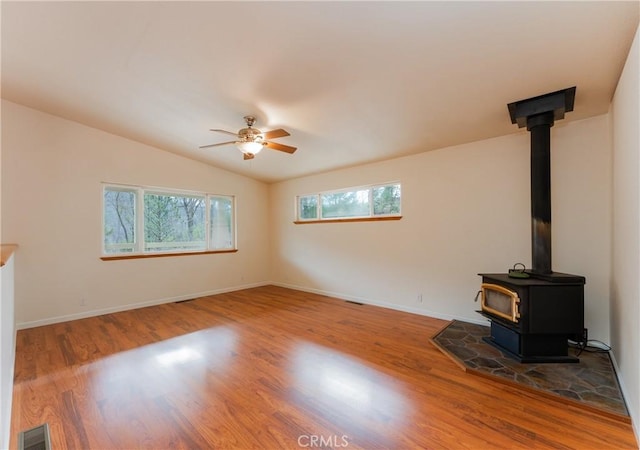 12625 Elk Mountain Rd, Upper Lake, CA 95485 - unfurnished living room with visible vents, vaulted ceiling, wood finished floors, and a wood stove