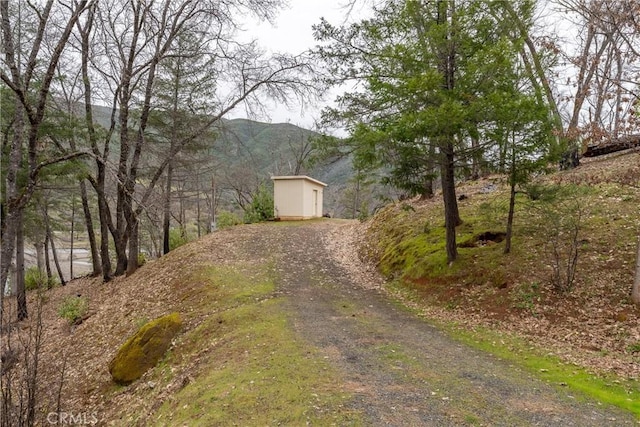 12625 Elk Mountain Rd, Upper Lake, CA 95485 - exterior space featuring a storage unit, driveway, an outbuilding, and a mountain view
