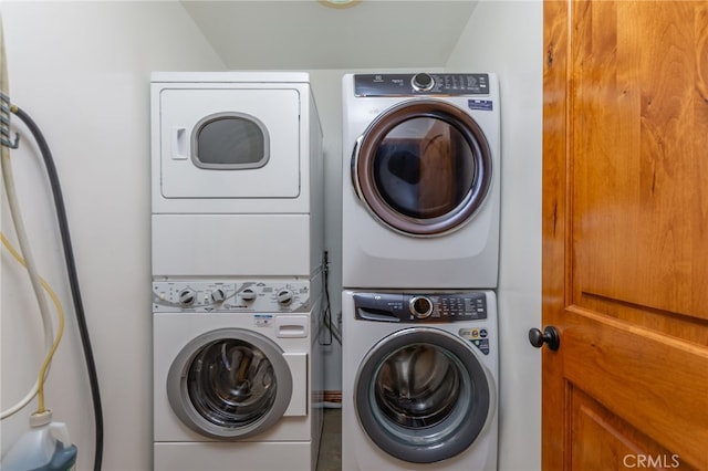 laundry area featuring stacked washing maching and dryer