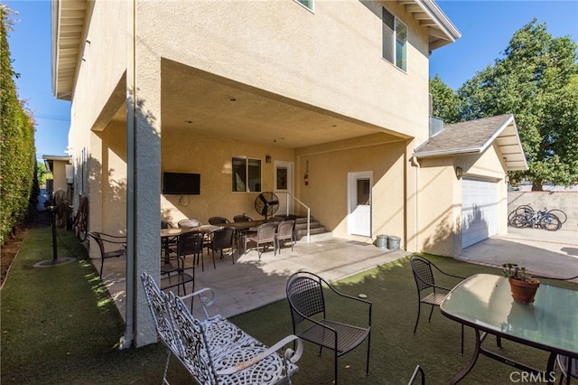 back of house with a patio and stucco siding