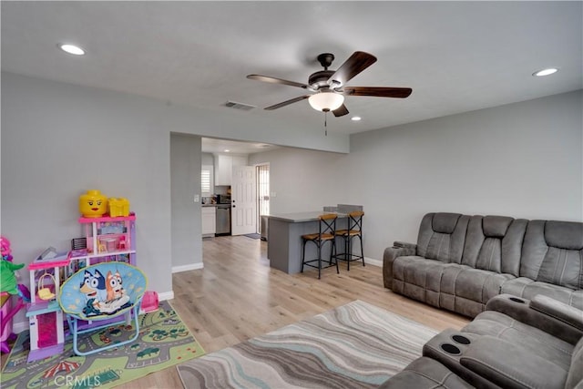 interior space with light wood-style floors, baseboards, visible vents, and recessed lighting